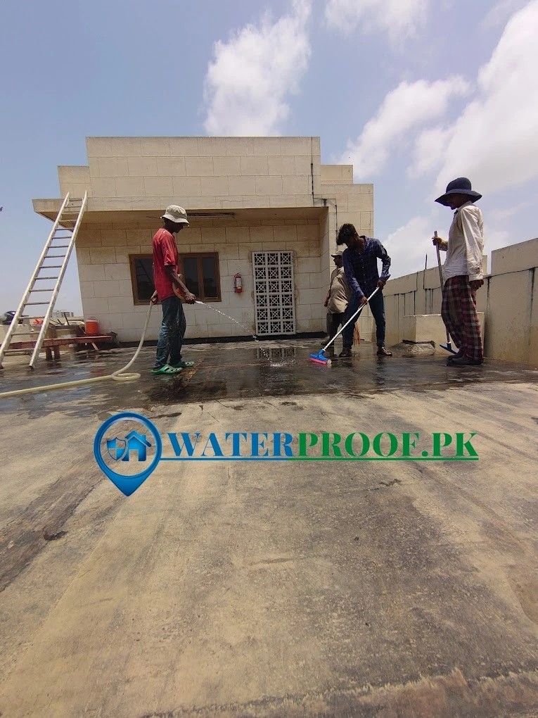 Waterproof.PK team applying roof waterproofing coating on a Karachi rooftop